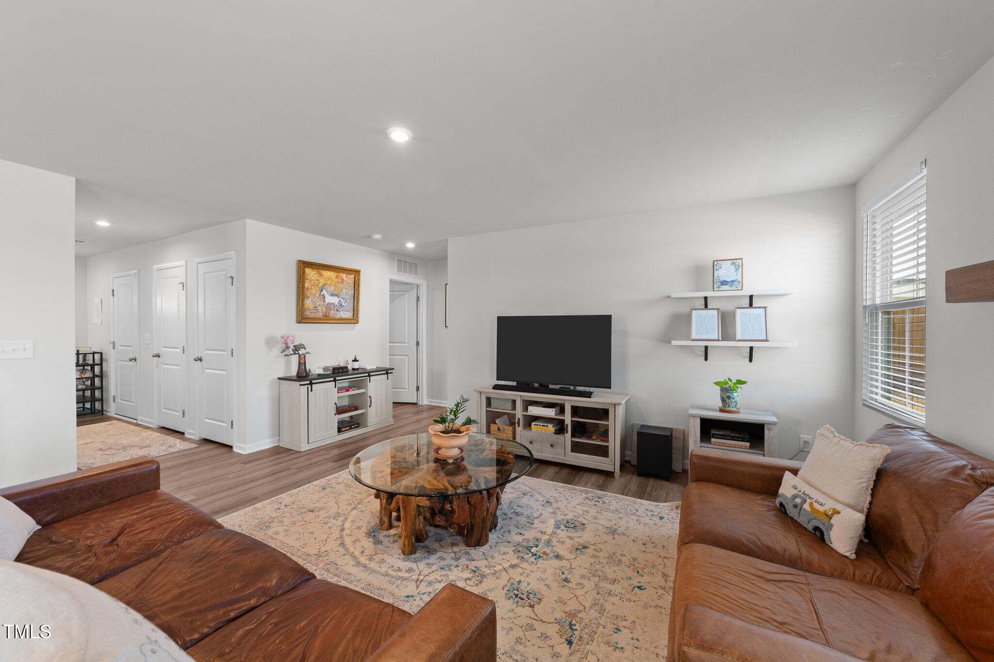 45 Florentine Court Angier, NC 27501 - Photo 15 of 27 a living room with furniture and a flat screen tv