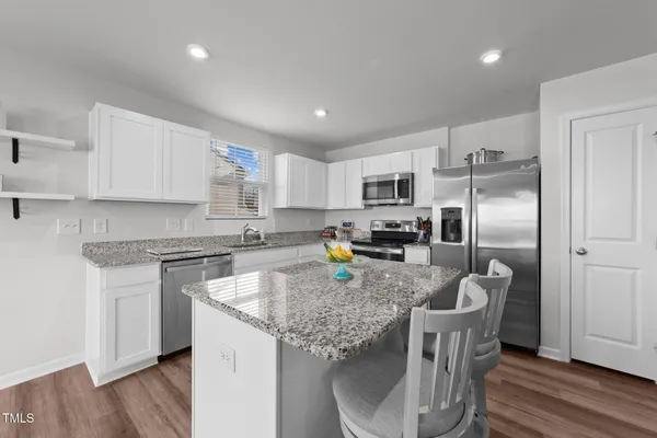 a kitchen with a stove sink and refrigerator