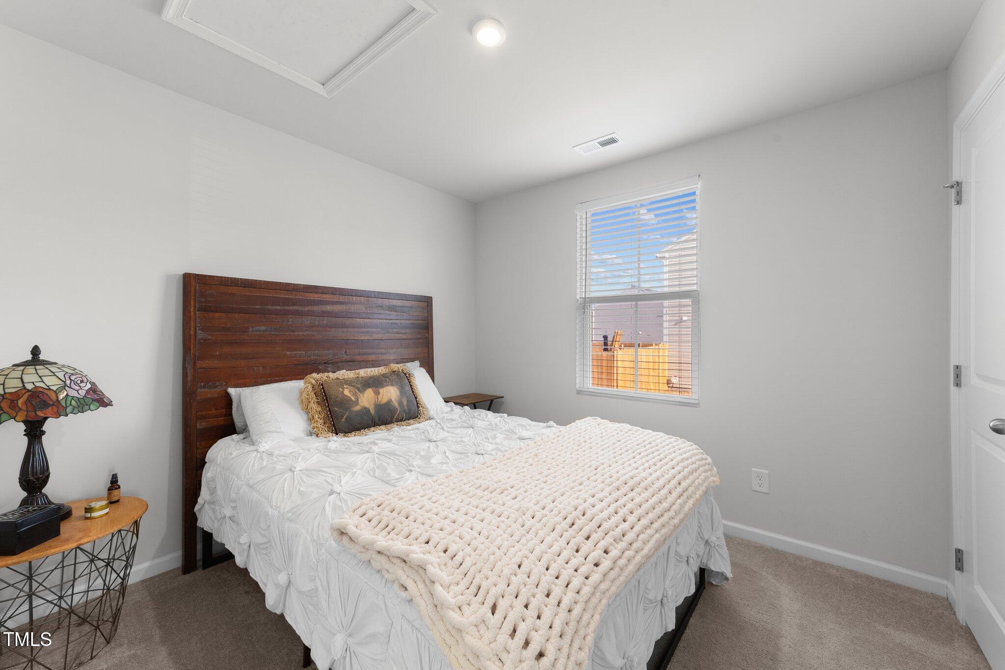 45 Florentine Court Angier, NC 27501 - Photo 25 of 27 a bedroom with a bed and window