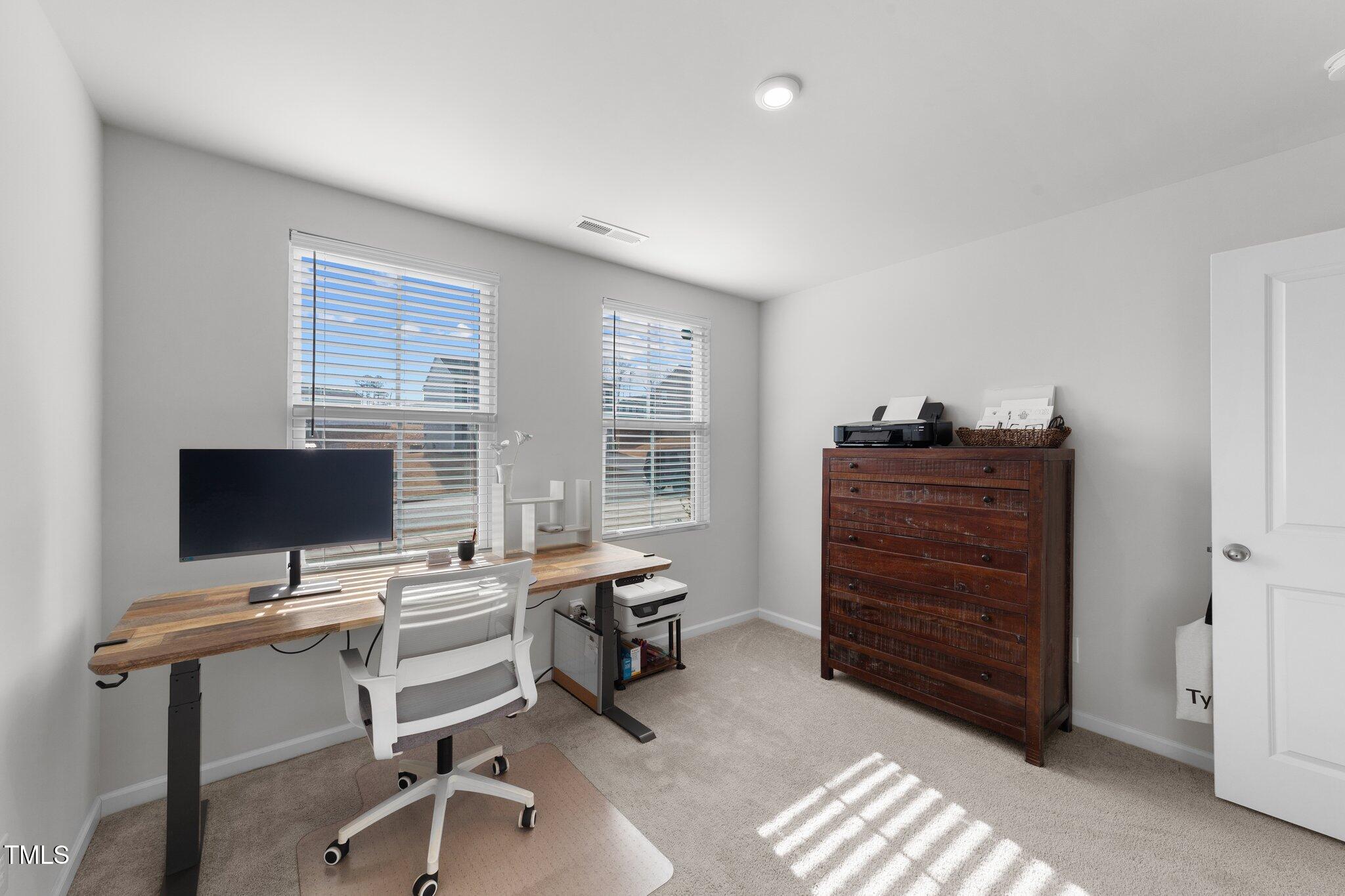 45 Florentine Court Angier, NC 27501 - Photo 26 of 27 a view of a workspace with furniture and a window