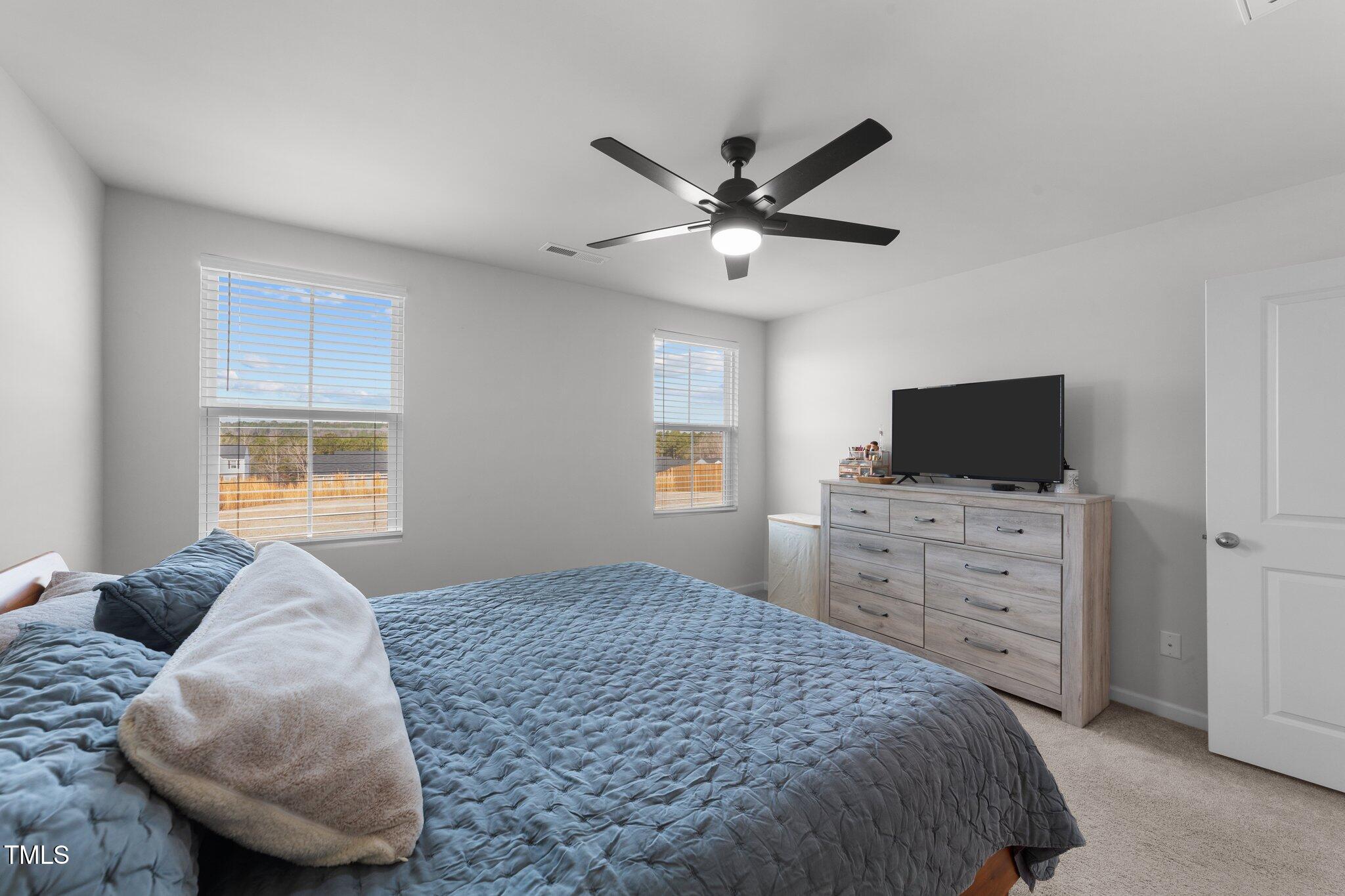 45 Florentine Court Angier, NC 27501 - Photo 7 of 27 a bedroom with a large bed and a flat screen tv