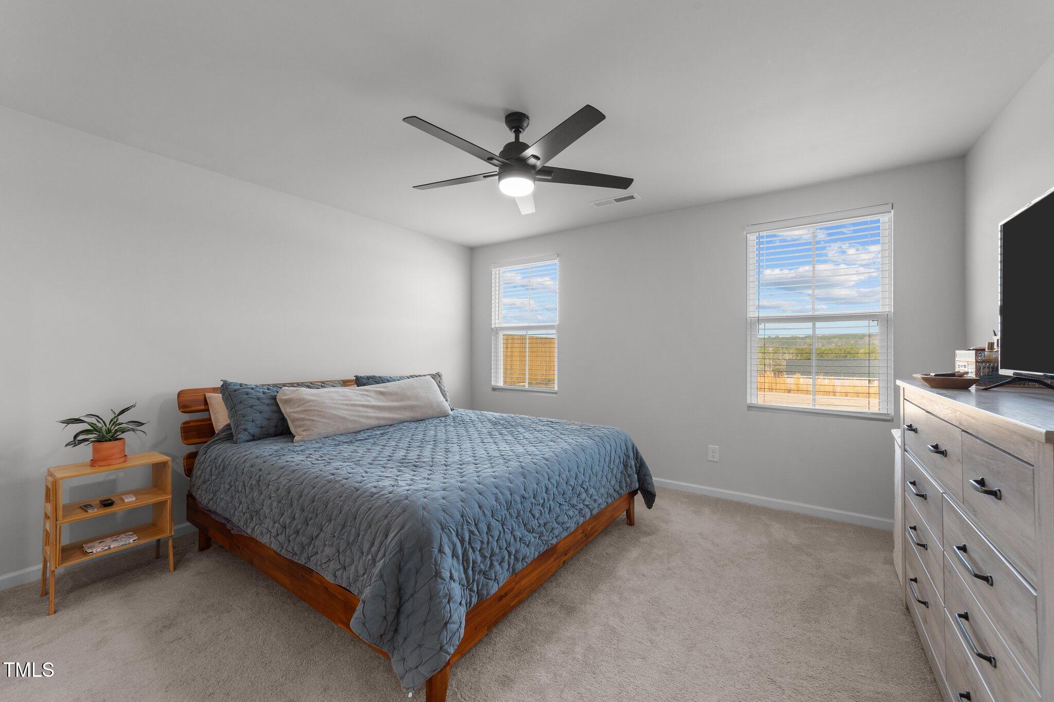 45 Florentine Court Angier, NC 27501 - Photo 8 of 27 a bedroom with a bed and a tv on dresser