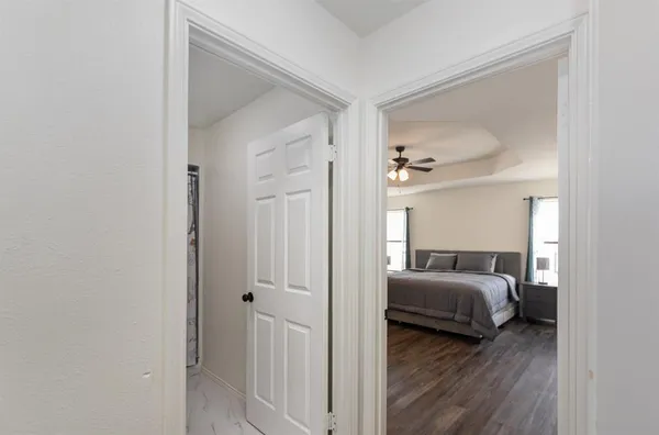 a view of a bedroom from bed and hallway