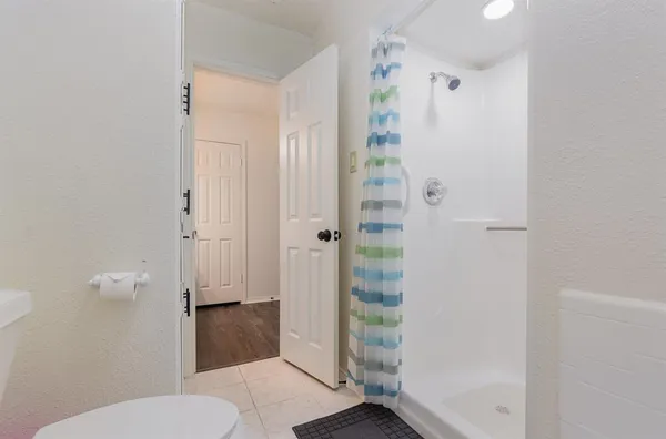 a bathroom with a shower and toilet