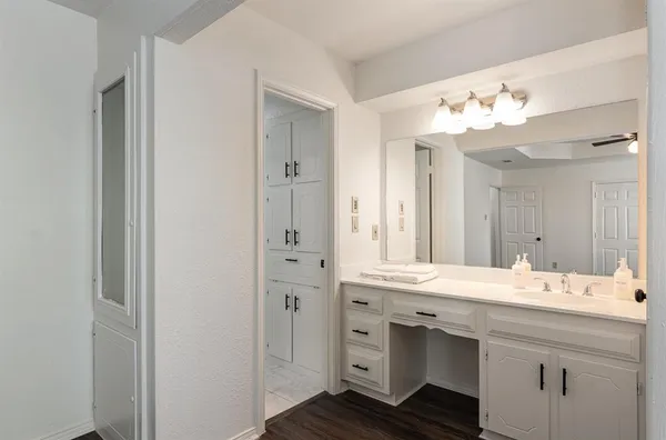 a bathroom with a sink vanity and a mirror