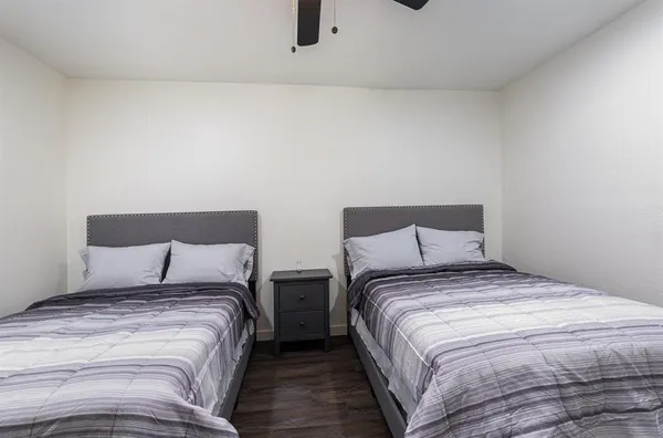 a bedroom with a bed and a night stand