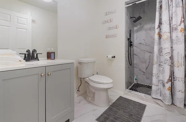a white toilet sitting next to a bathroom sink