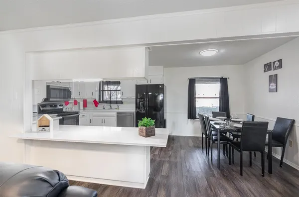 a view of a dining room with furniture and wooden floor