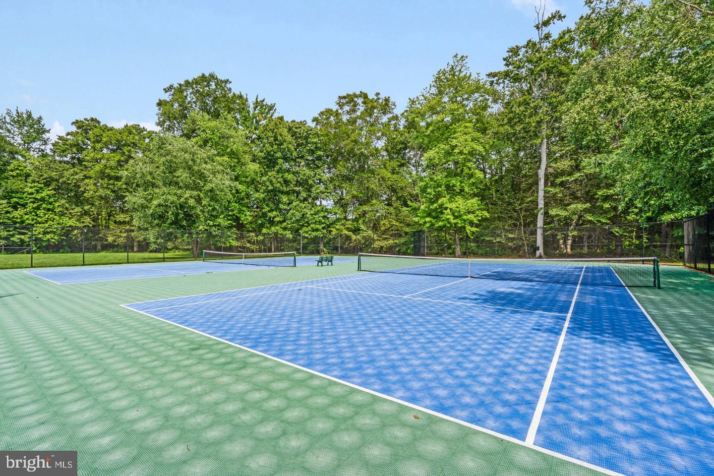 99 Warwick Road Princeton Junction, NJ 08550 - Photo 42 of 45 Serene tennis courts in nature's embrace.
