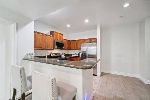 a kitchen with stainless steel appliances granite countertop a sink stove and cabinets