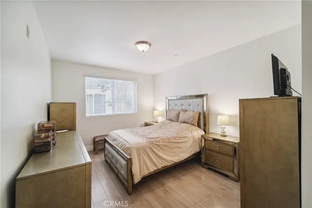 a bedroom with a bed next to a window