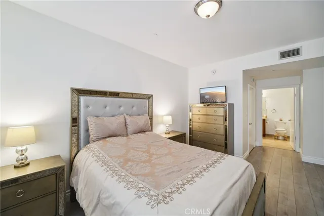 a bedroom with a bed and a lamp