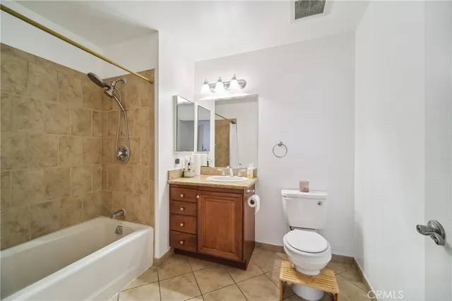 a bathroom with a granite countertop toilet a sink and bathtub