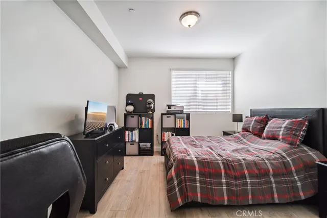 a bedroom with a bed and windows