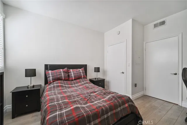 a bedroom with a bed and a night stand