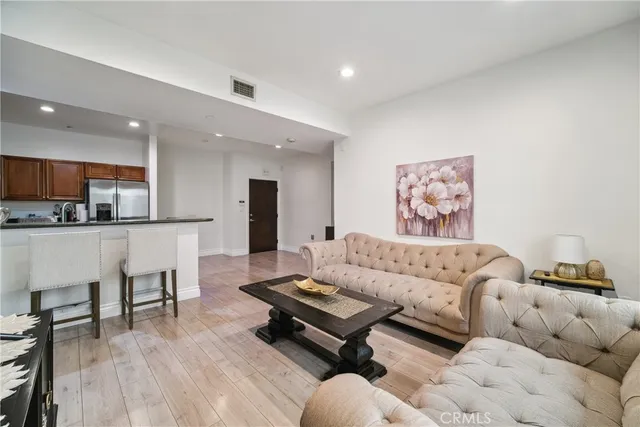 a living room with furniture and kitchen view