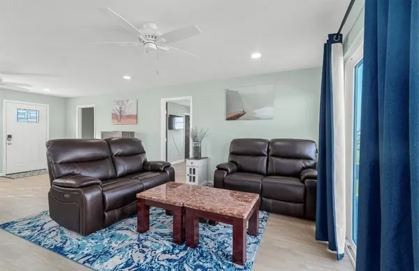 a living room with furniture and wooden floor