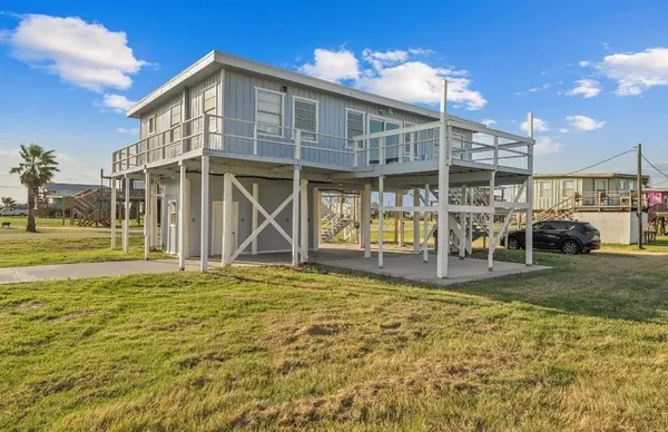 an aerial view of residential houses with outdoor space and ocean view
