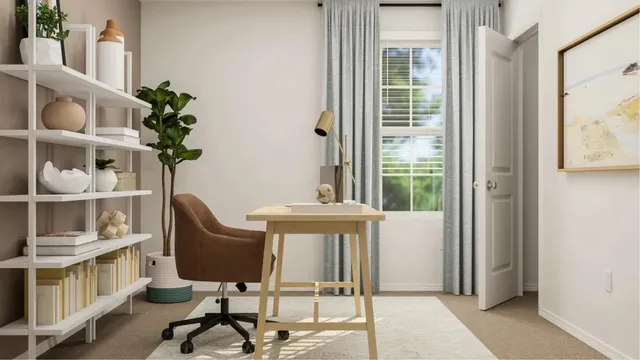 a view of a workspace with furniture and a window