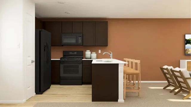 a kitchen with a refrigerator and a stove top oven