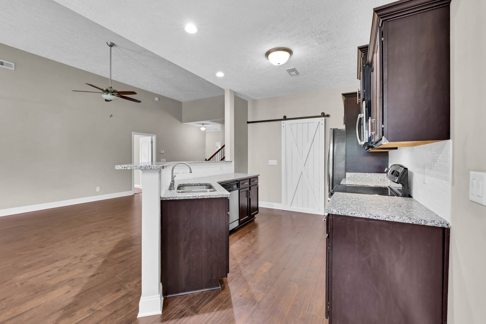 987 Promenade Drive Adams, TN 37010 - Photo 11 of 34 a kitchen with kitchen island a sink appliances and cabinets