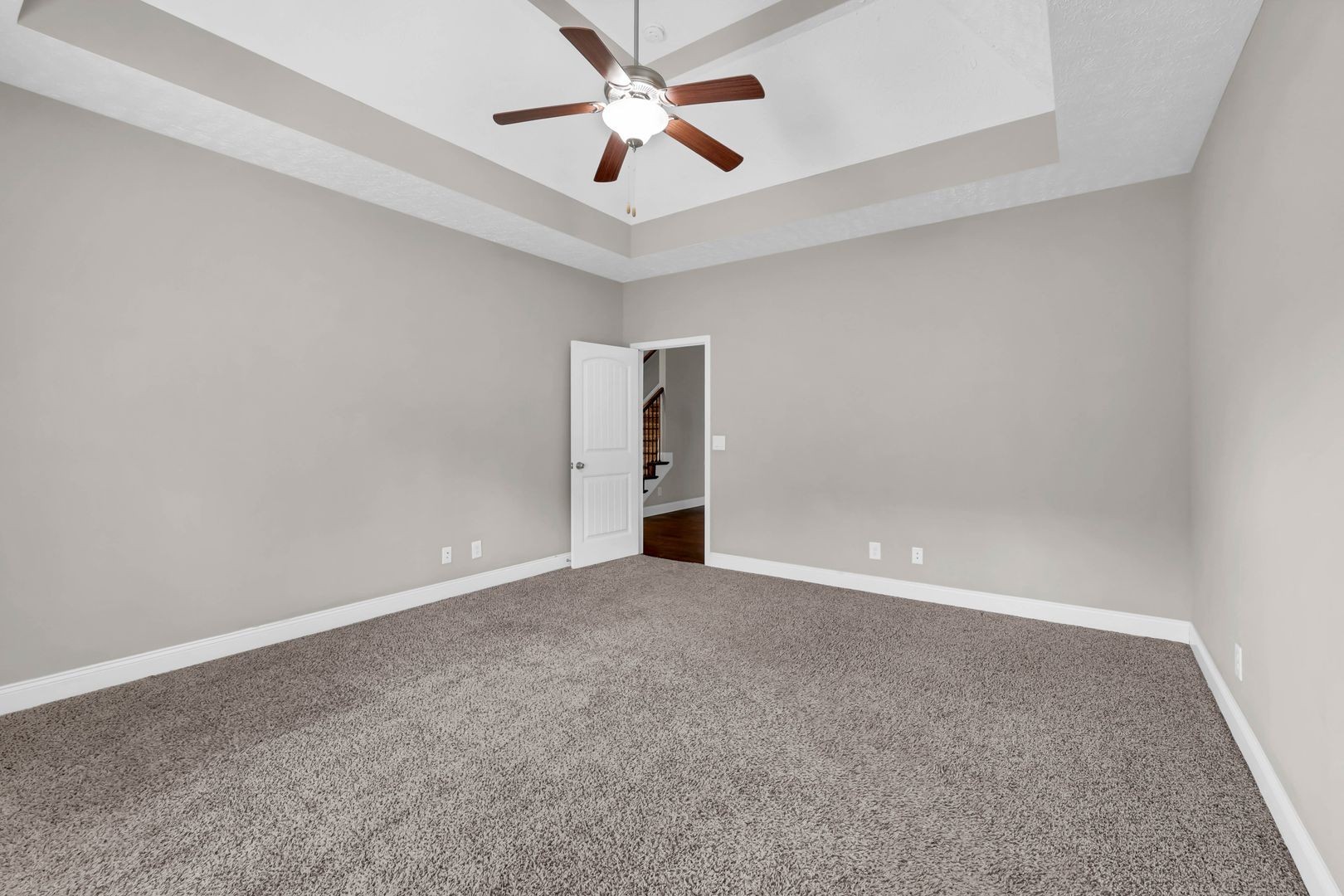 987 Promenade Drive Adams, TN 37010 - Photo 16 of 34 an empty room with a ceiling fan and carpet