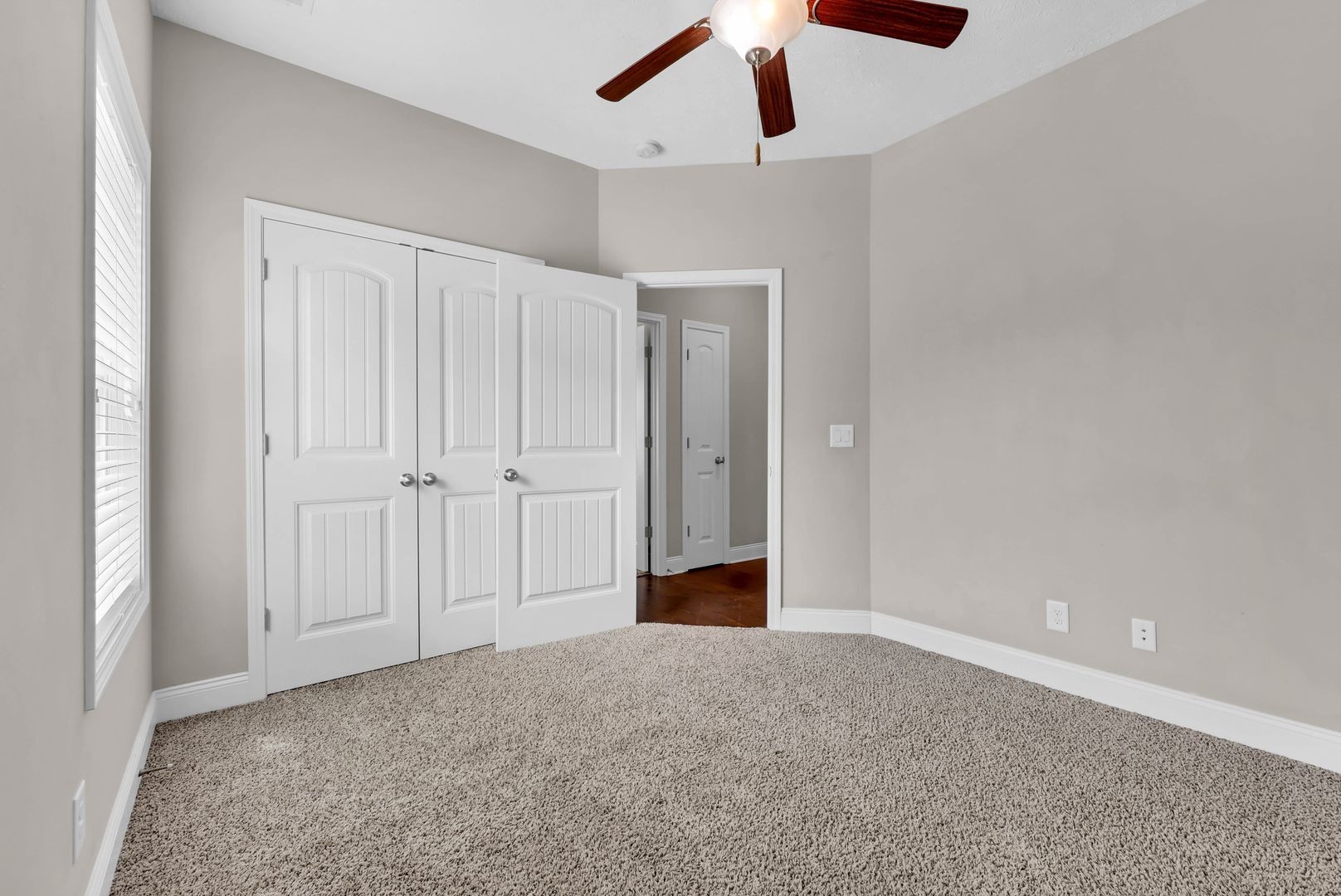 987 Promenade Drive Adams, TN 37010 - Photo 23 of 34 an empty room with a ceiling fan and carpet