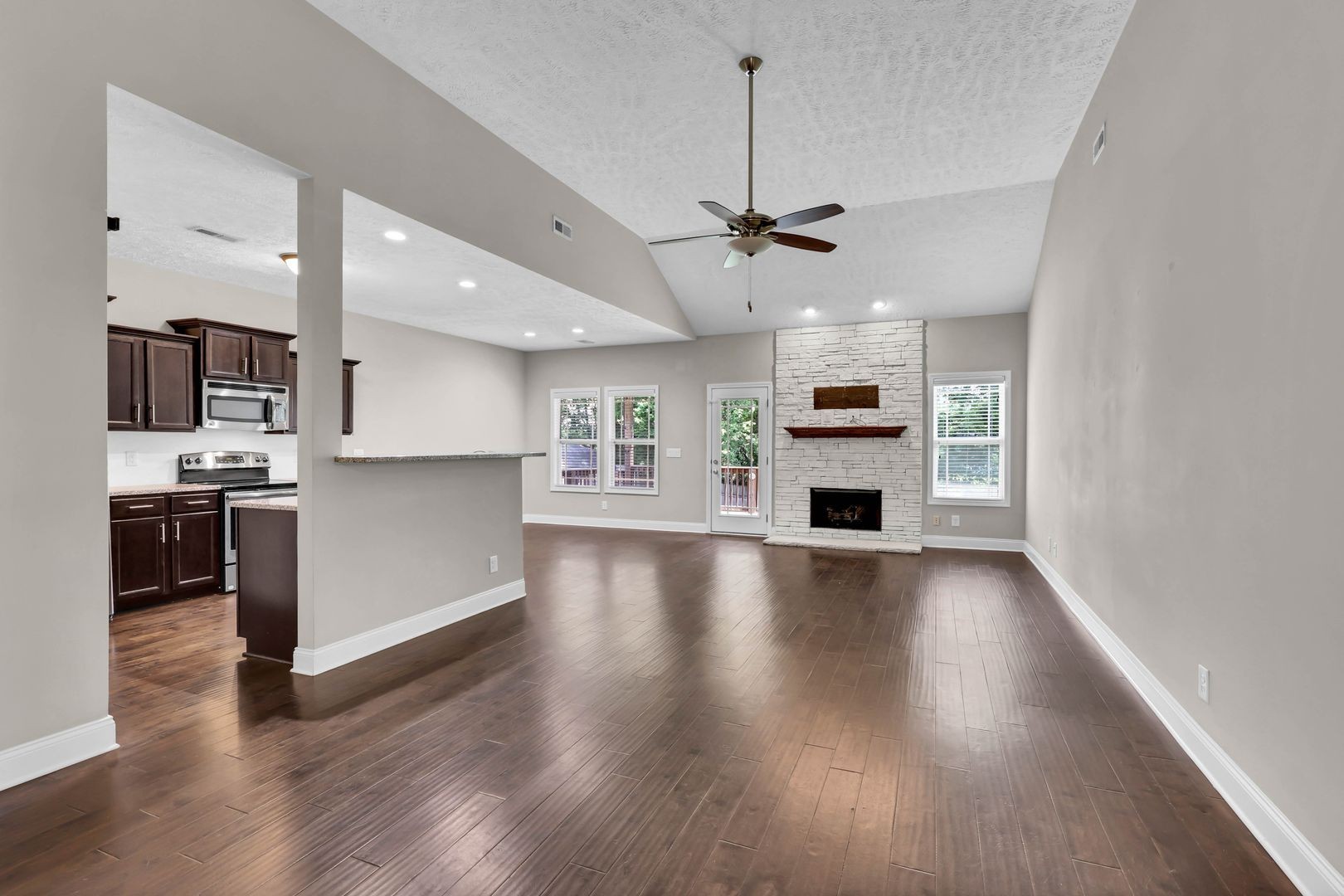987 Promenade Drive Adams, TN 37010 - Photo 6 of 34 a view of a kitchen with a sink stove cabinets and empty room