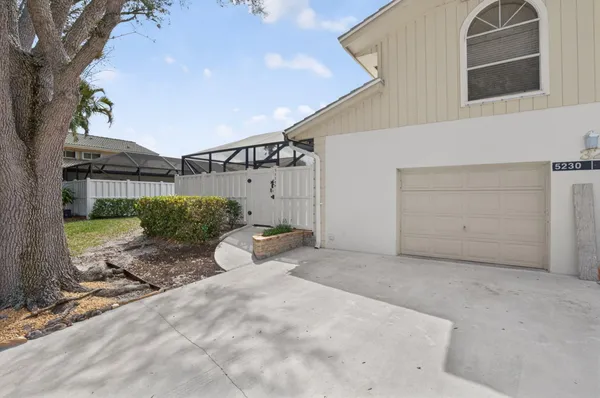 a view of a house with a backyard and a garage