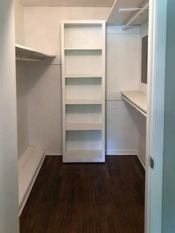 602 West 3rd Street Justin, TX 76247 - Photo 10 of 22 Spacious closet featuring wood-finish flooring, built-in shelving, and white walls