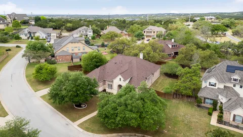 an aerial view of residential houses with outdoor space and river