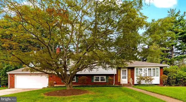 a large tree in front of a house