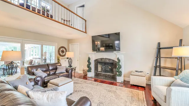 a living room with furniture a fireplace and a flat screen tv