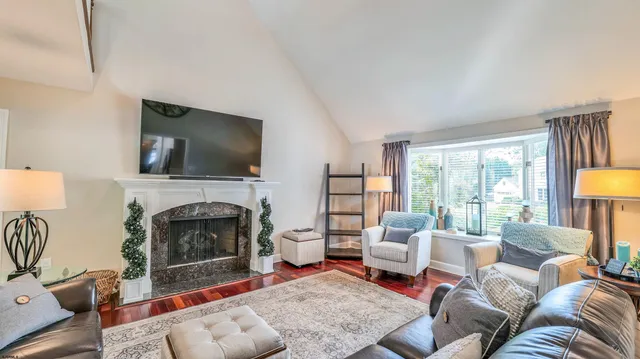 a view of a dining room with furniture a chandelier and wooden floor
