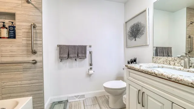 a en suite bathroom with a sink mirror and a bathtub