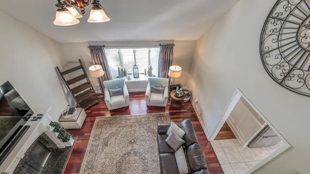 a living room with furniture and floor to ceiling windows