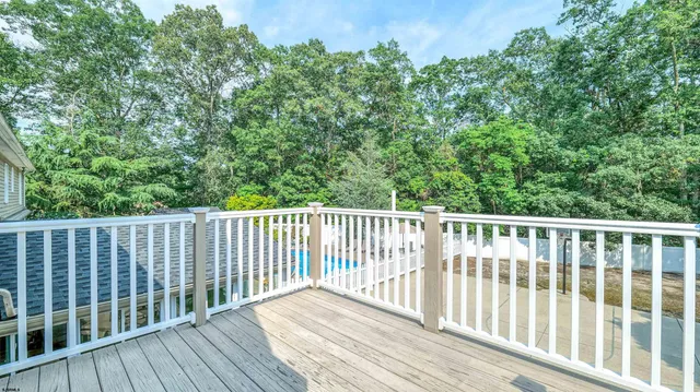 a view of a patio with a table and chairs under an umbrella