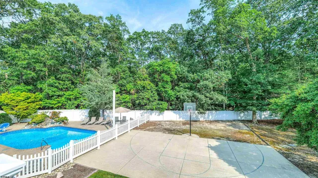 a aerial view of a house with a yard and furniture