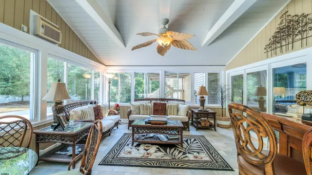 an aerial view of a house with a garden and lake view
