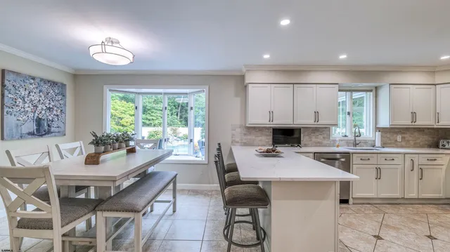 a kitchen with a table chairs sink and cabinets