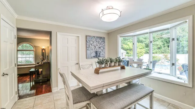 a kitchen with granite countertop a sink a stove top oven a refrigerator and cabinets