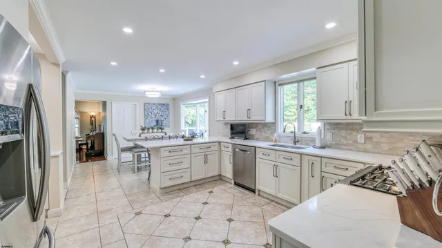 a kitchen with white cabinets and white appliances
