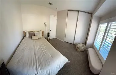 a bed room with a bed and a mirror