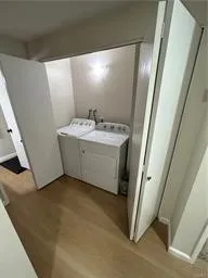 a view of a hallway with washer and dryer