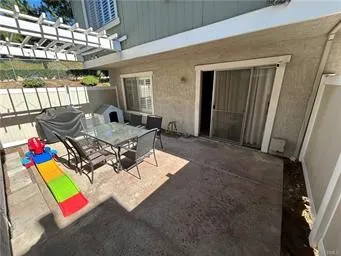 a view of a chairs and table in patio