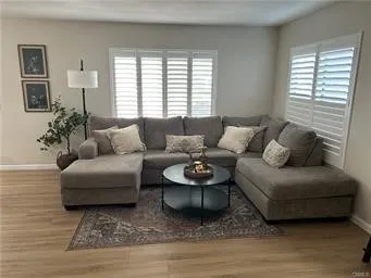 a living room with furniture and a large window