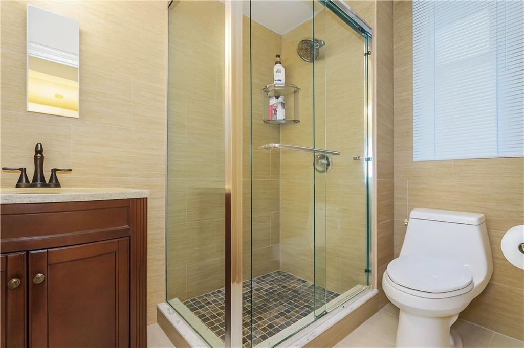 70 Remsen Street, Unit 4F Brooklyn, NY 11201 - Photo 8 of 11 a bathroom with a toilet a sink and shower