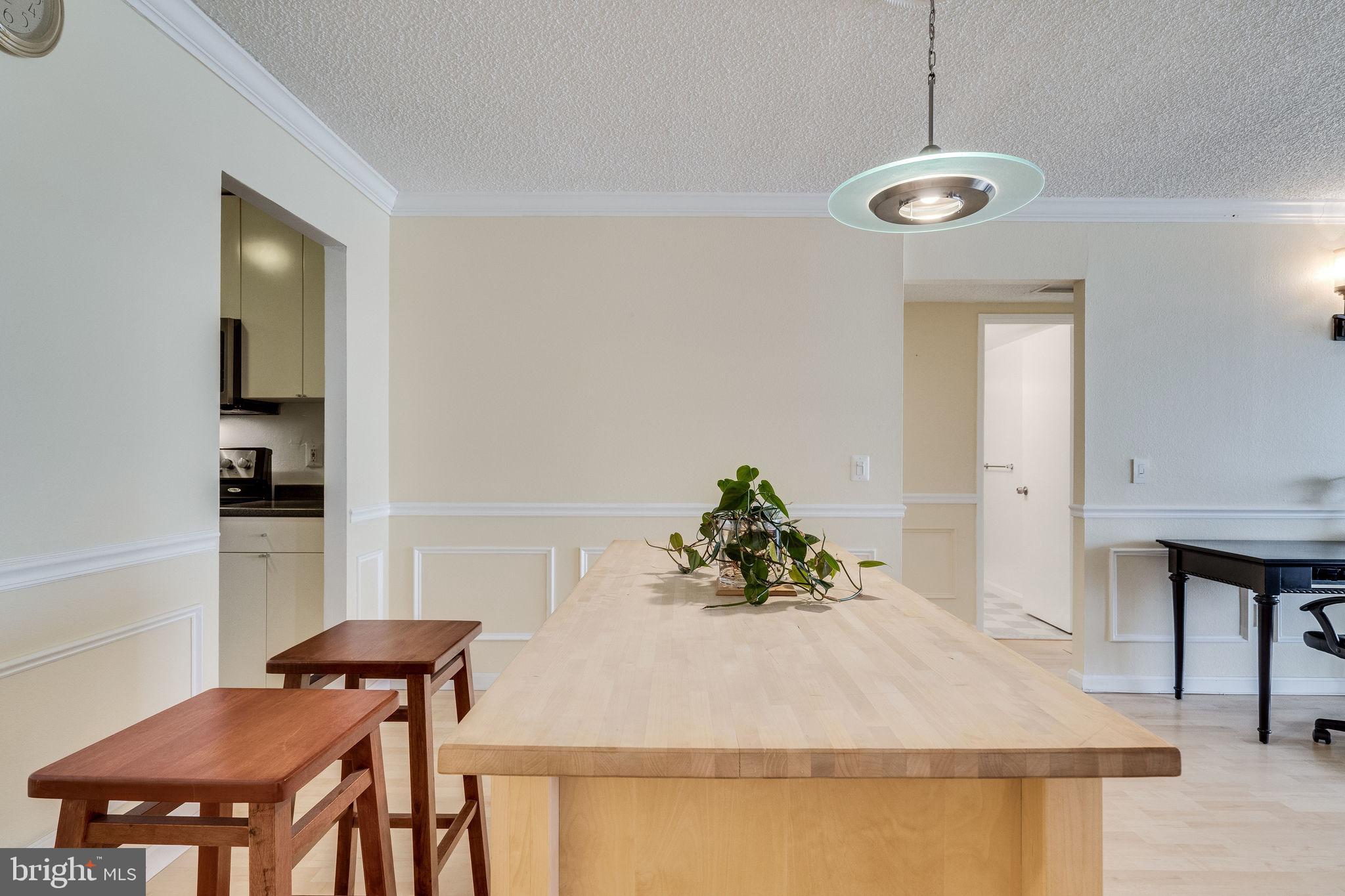 6101 Edsall Road, Unit 905 Alexandria, VA 22304 - Photo 19 of 62 a view of a dining room with furniture and wooden floor