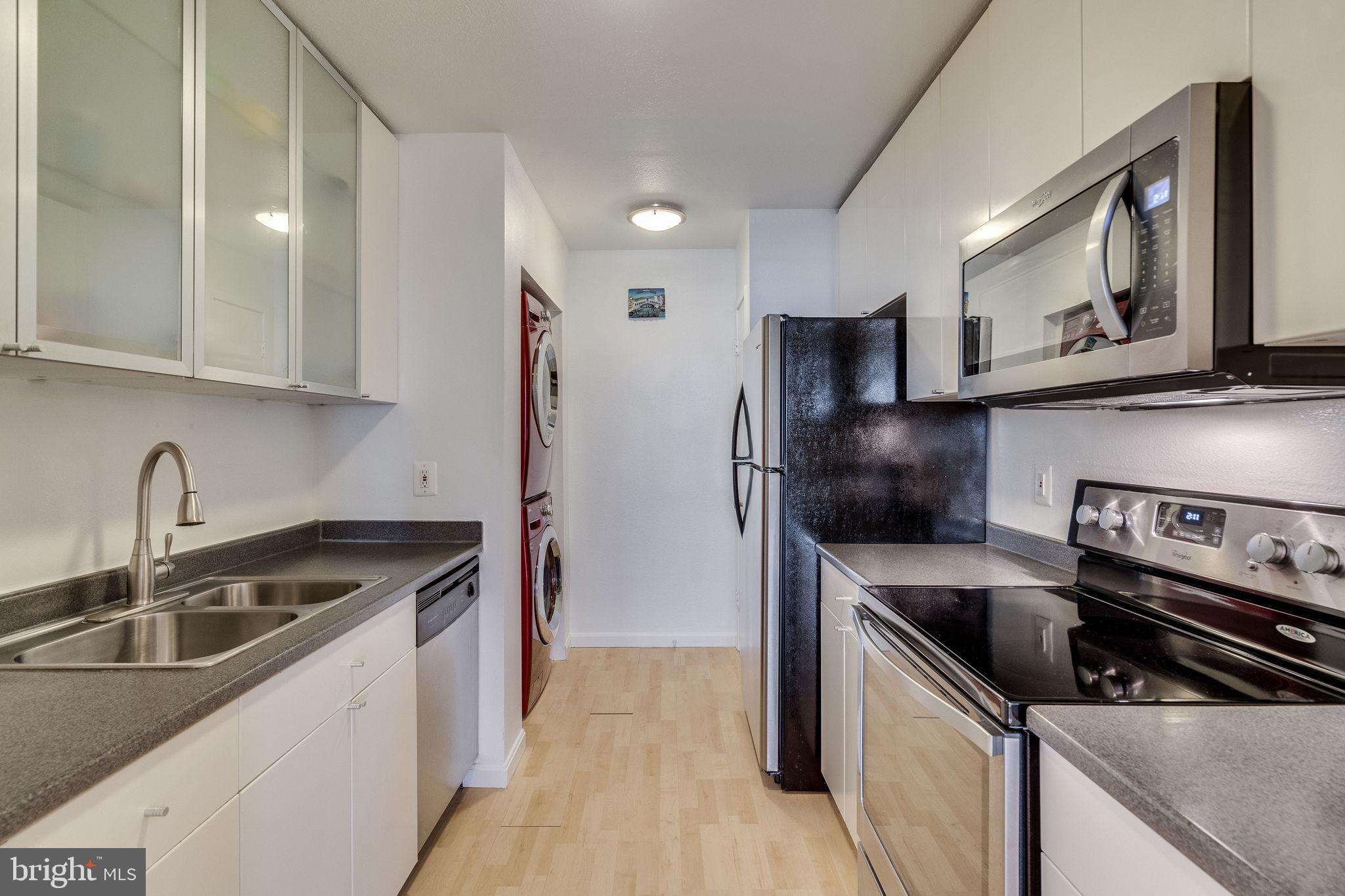 6101 Edsall Road, Unit 905 Alexandria, VA 22304 - Photo 20 of 62 a kitchen that has a sink stainless steel appliances and cabinets