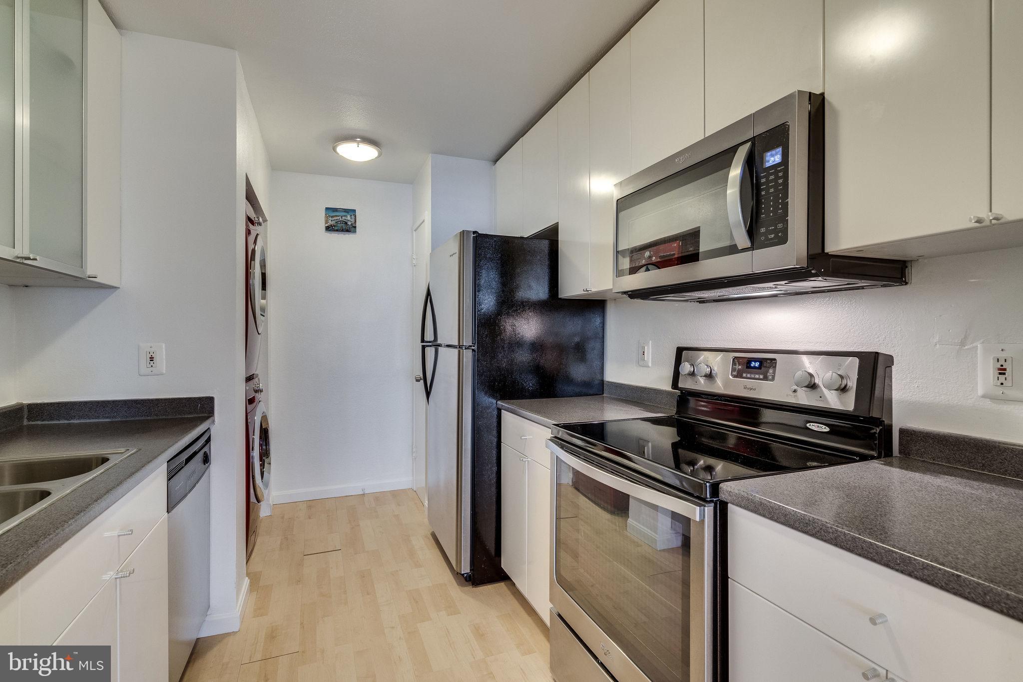 6101 Edsall Road, Unit 905 Alexandria, VA 22304 - Photo 22 of 62 a kitchen with stainless steel appliances granite countertop a stove microwave and refrigerator
